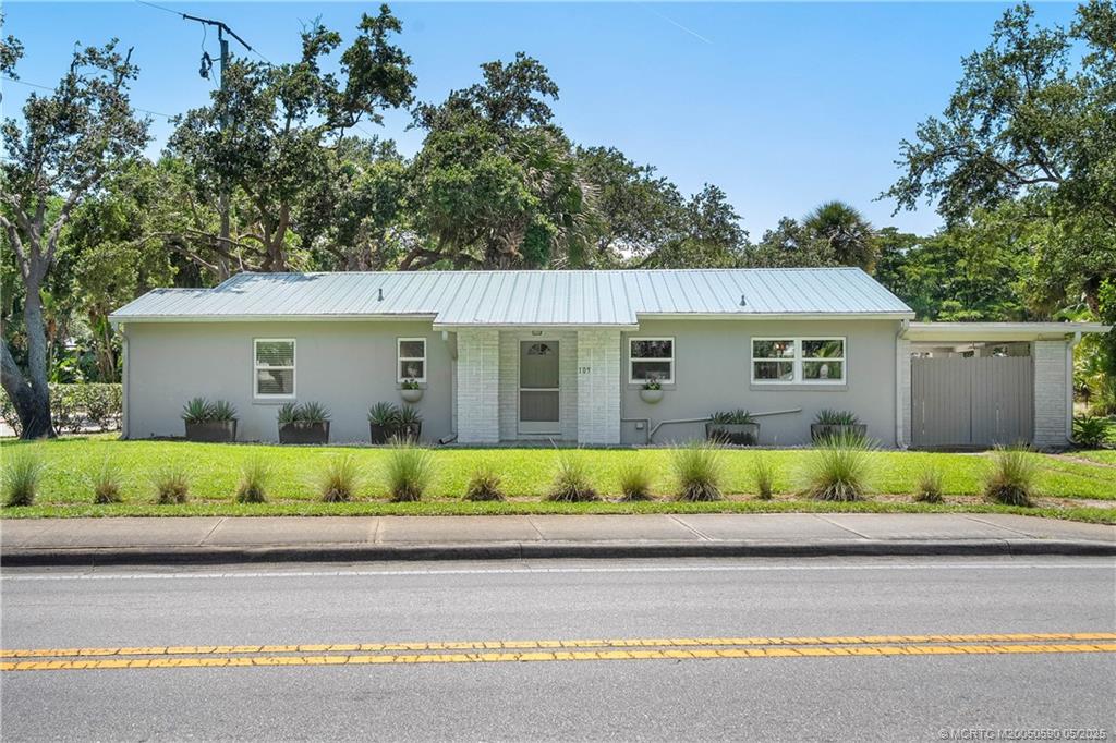 109 North Sewalls Point Road Stuart, FL 34996 - Photo 23 of 33 a view of house with a garden and pathway