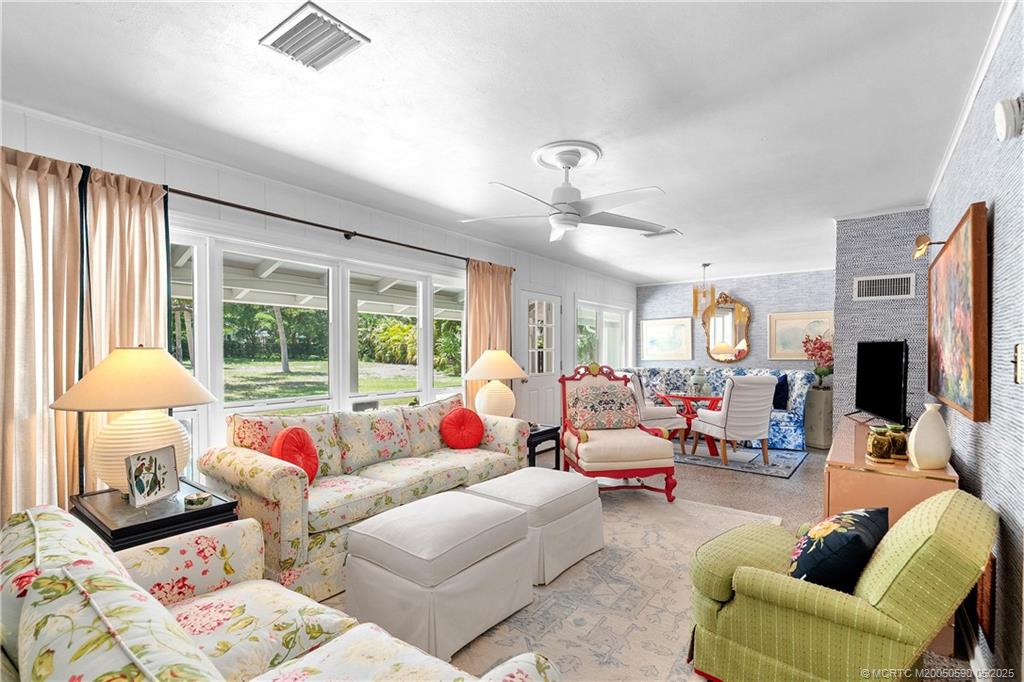 109 North Sewalls Point Road Stuart, FL 34996 - Photo 8 of 33 a living room with furniture fireplace and a large window