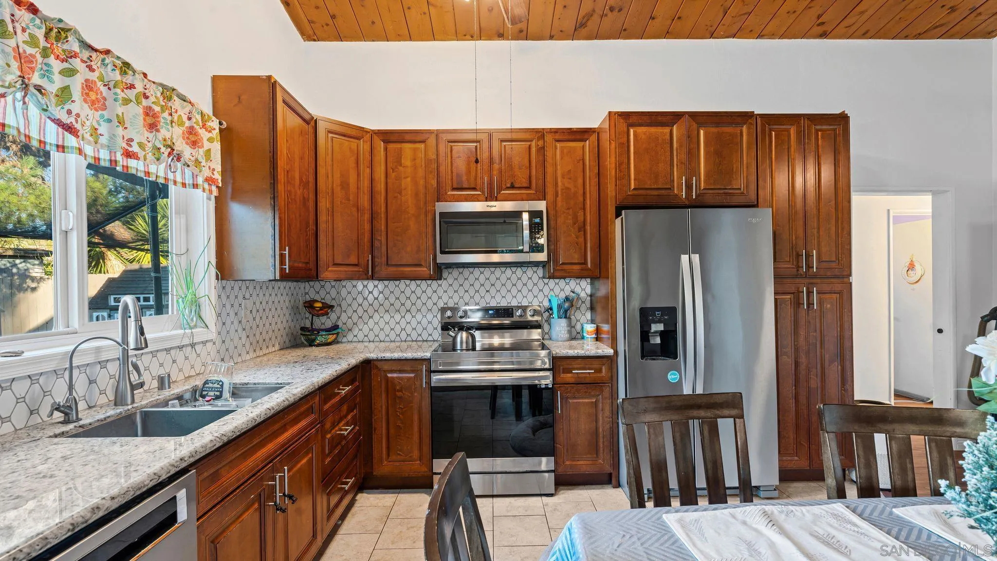 9144 Fanita Rancho Road Santee, CA 92071 - Photo 11 of 28 a kitchen with stainless steel appliances granite countertop a refrigerator a stove and a sink with wooden floors