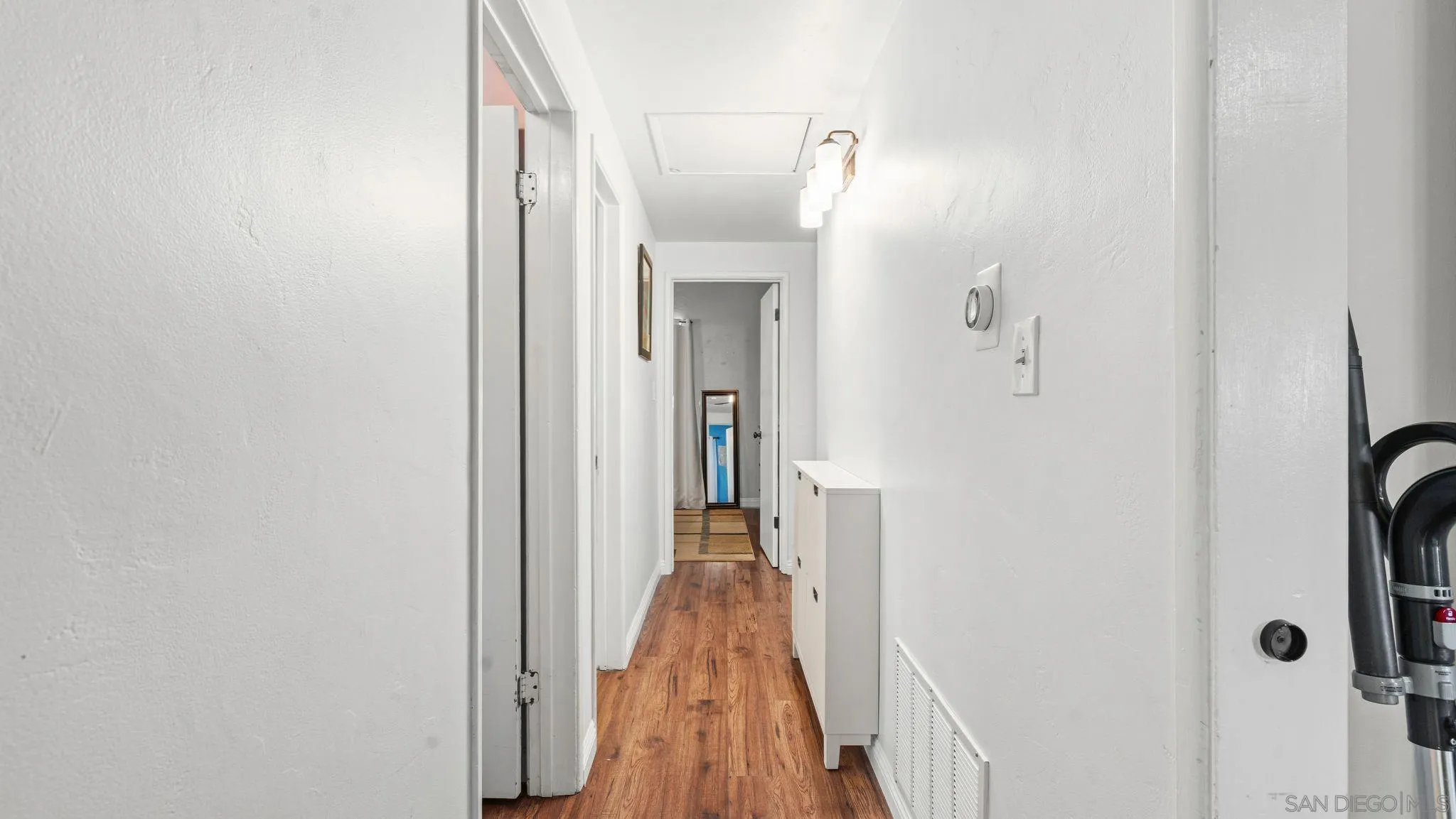9144 Fanita Rancho Road Santee, CA 92071 - Photo 13 of 28 a view of a hallway with wooden floor and a bathroom