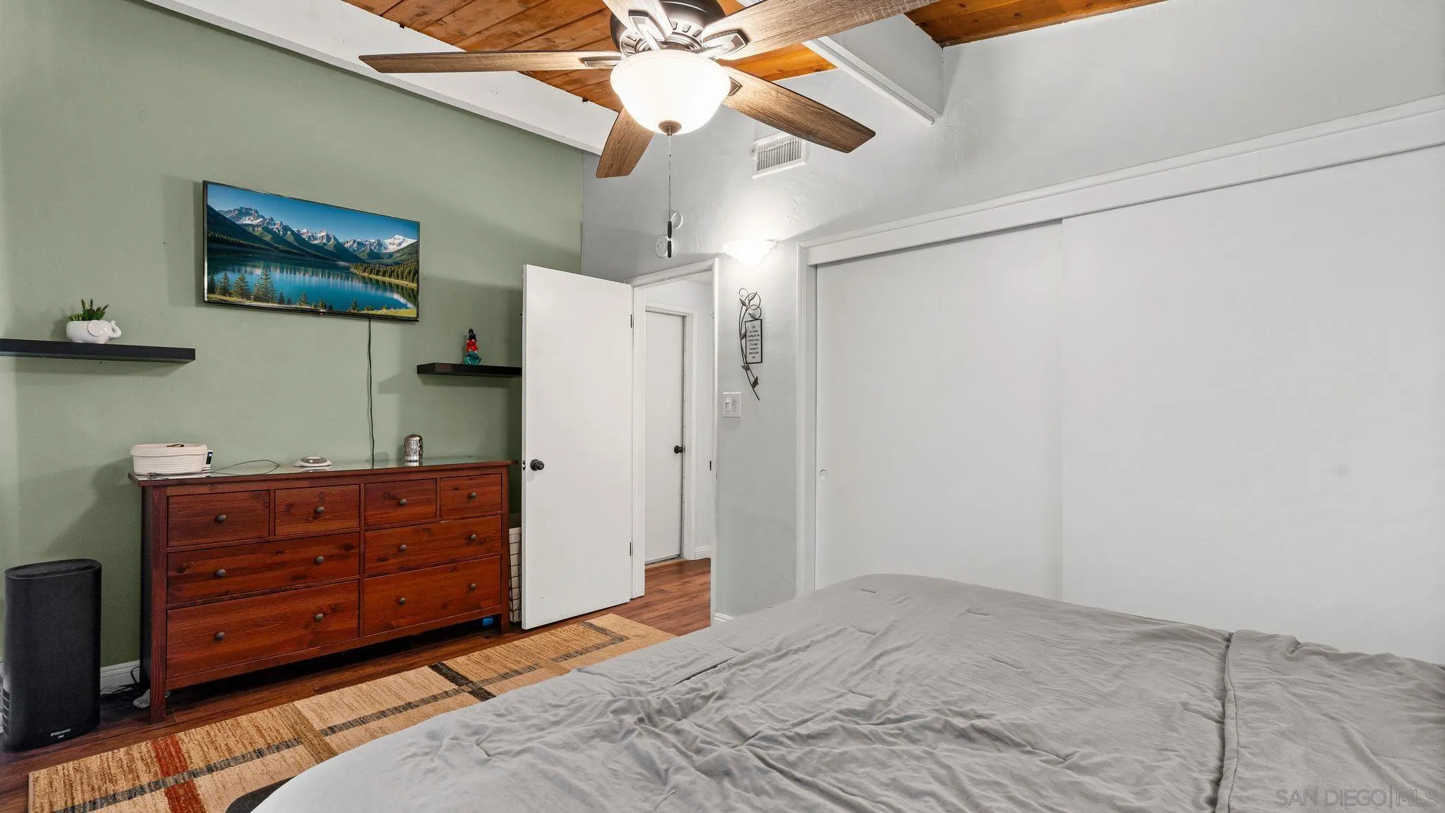 9144 Fanita Rancho Road Santee, CA 92071 - Photo 16 of 28 a bedroom with a dresser and a chandelier
