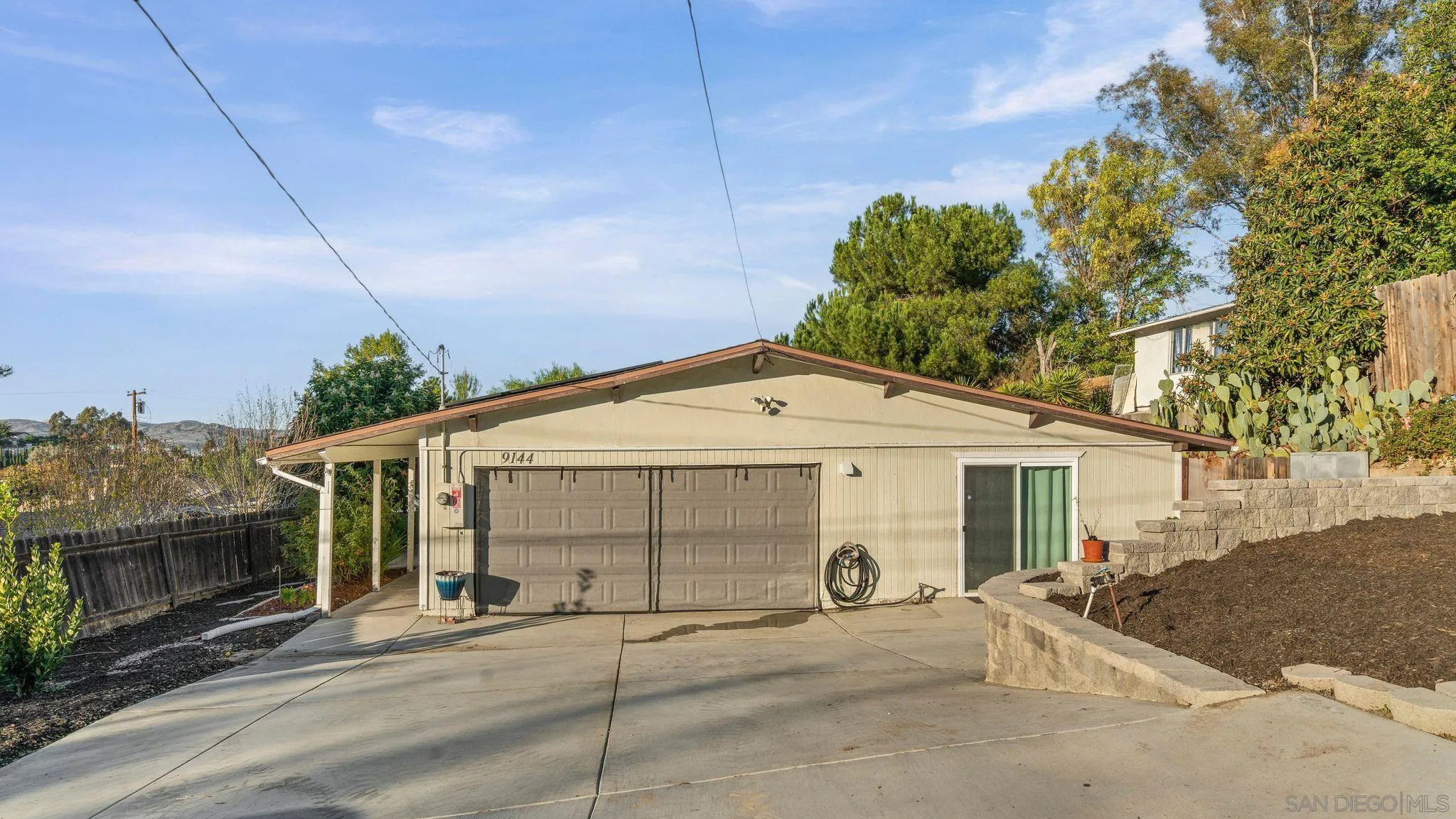 9144 Fanita Rancho Road Santee, CA 92071 - Photo 2 of 28 a front view of a house with a yard and garage