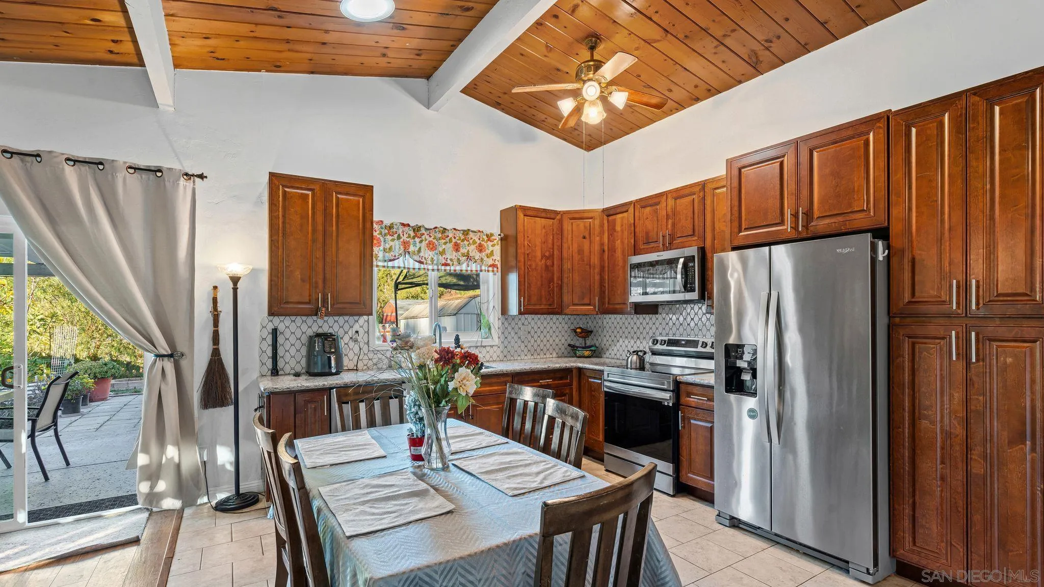 9144 Fanita Rancho Road Santee, CA 92071 - Photo 10 of 28 a kitchen with granite countertop a refrigerator a stove a sink dishwasher and wooden cabinets