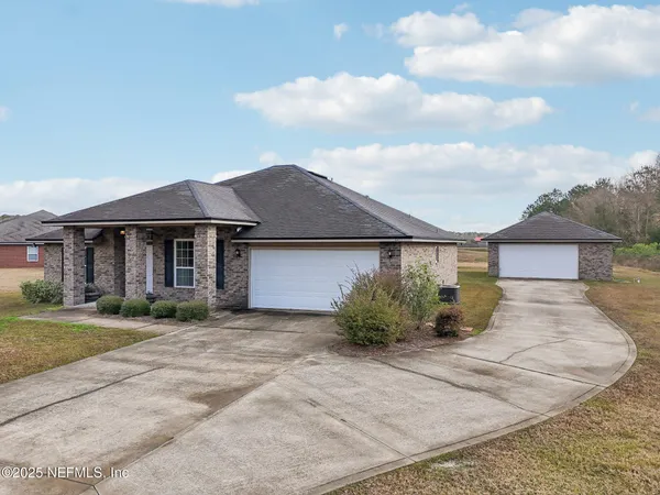 an aerial view of a house with a yard basket ball court and outdoor seating