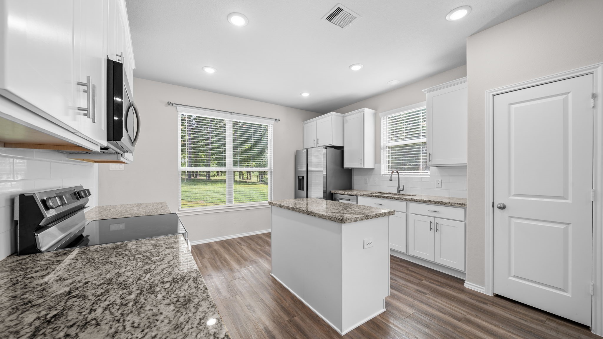 18140 Mail Rte Road Montgomery, TX 77316 - Photo 9 of 26 Enjoy meal preparation in this well-appointed kitchen with modern finishes, abundant storage, and a functional center island.