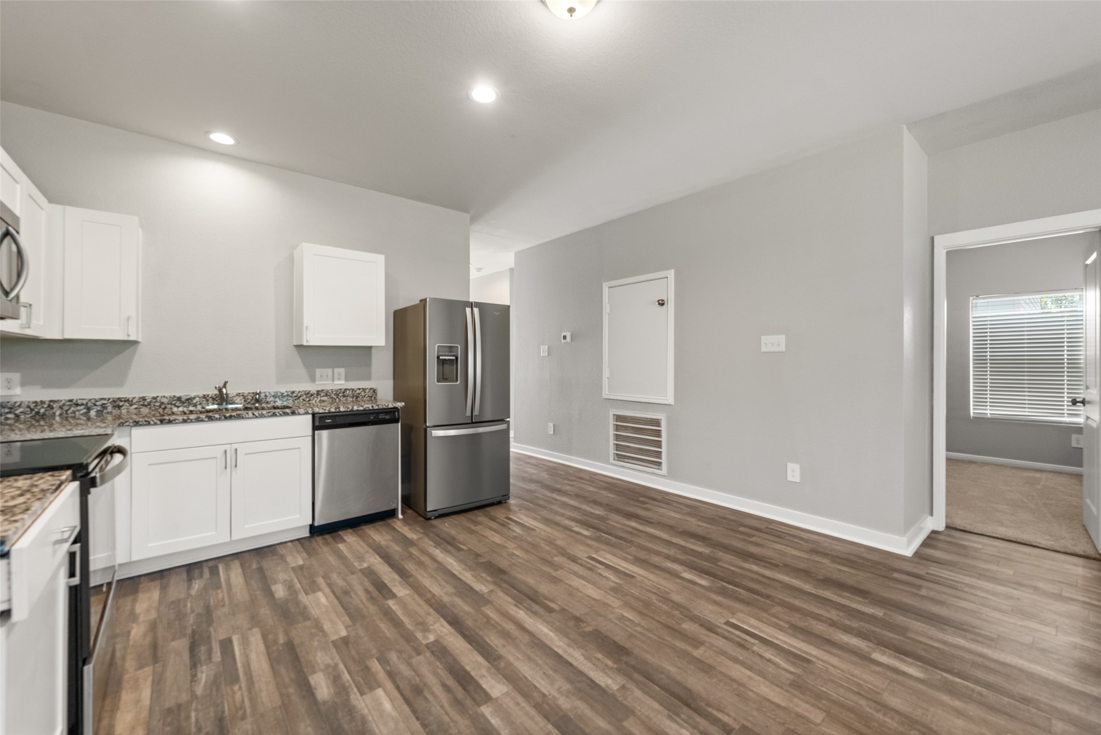 2537 18th Street Hempstead, TX 77445 - Photo 11 of 28 Kitchen and dining view featuring stainless steel appliances, abundant cabinetry, recessed lighting, and an open connection to the living area.