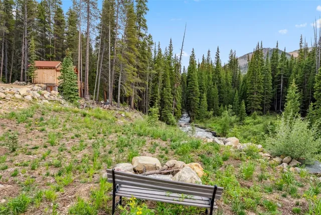 a view of a yard with plants and outdoor seating