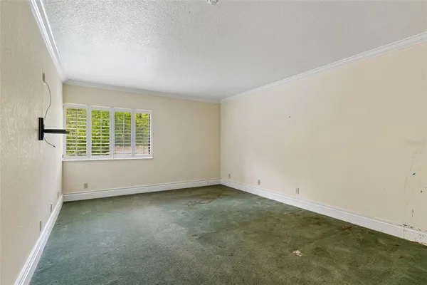 an aerial view of a houses with a yard and lake view