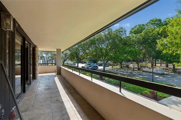 a view of a patio with couches chairs and potted plants
