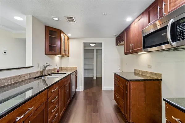 a view of kitchen with furniture and refrigerator