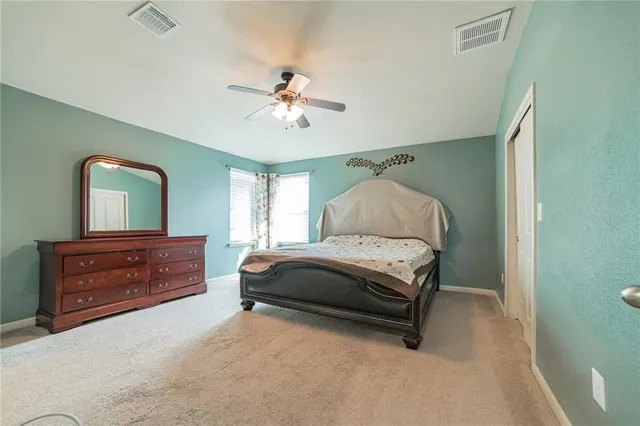 a bedroom with a bed and window