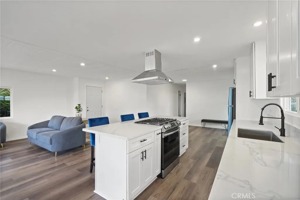 3033 E Valley, Unit 89 West Covina, CA 91792 - Photo 14 of 55 a kitchen with stainless steel appliances granite countertop a stove a sink and a refrigerator
