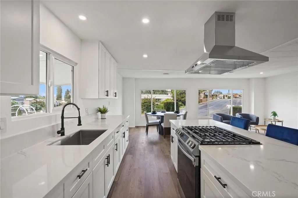 3033 E Valley, Unit 89 West Covina, CA 91792 - Photo 15 of 55 a kitchen with counter top space a sink stove and cabinets
