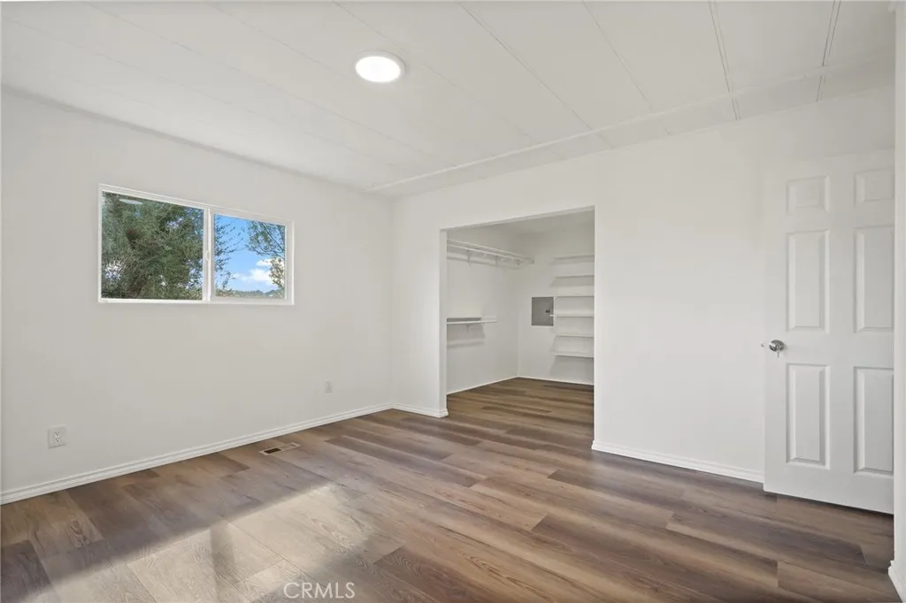 3033 E Valley, Unit 89 West Covina, CA 91792 - Photo 24 of 55 a view of an empty room with wooden floor and a window