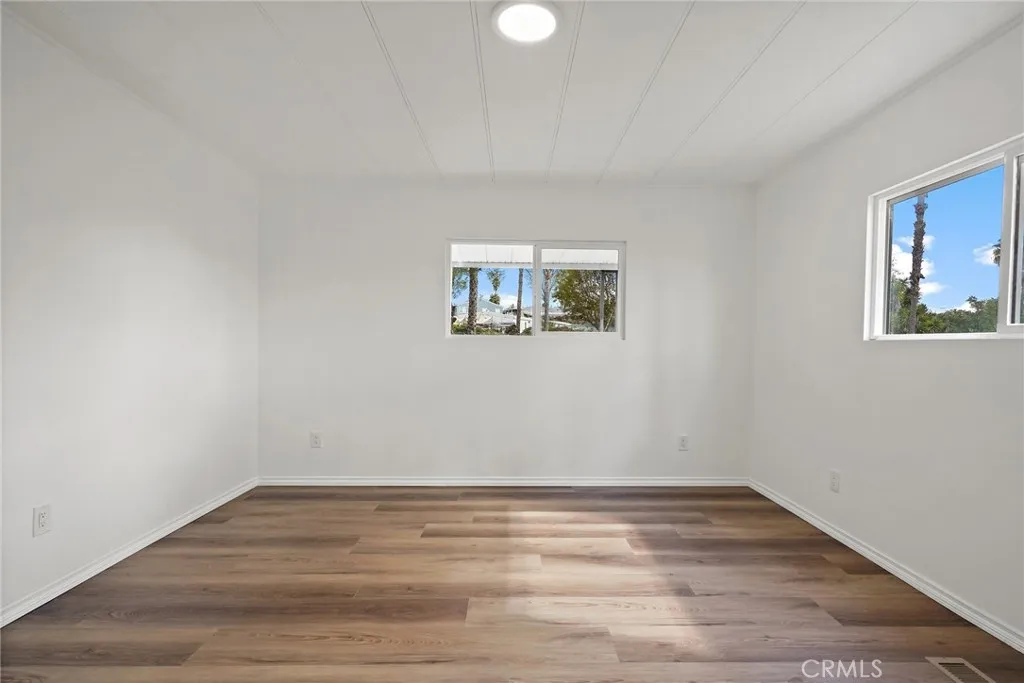 3033 E Valley, Unit 89 West Covina, CA 91792 - Photo 25 of 55 a view of a room that has wooden floor and window