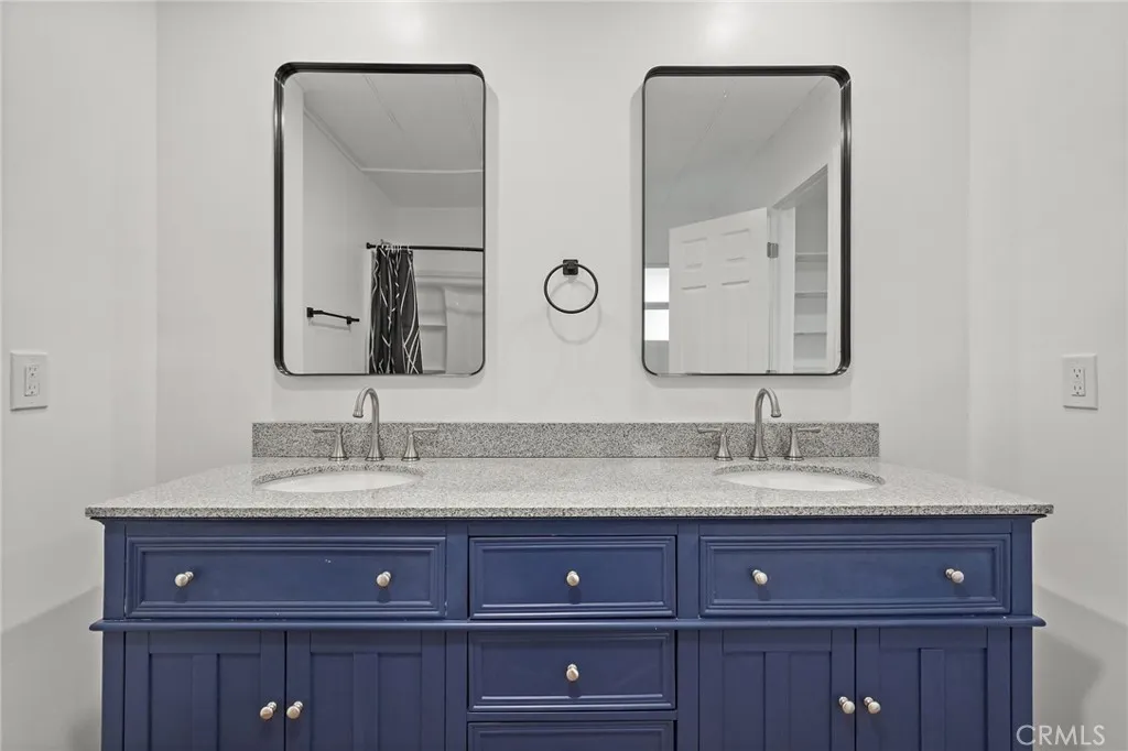 3033 E Valley, Unit 89 West Covina, CA 91792 - Photo 29 of 55 a bathroom with a double vanity sink and a mirror