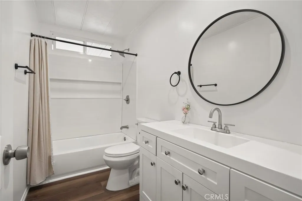3033 E Valley, Unit 89 West Covina, CA 91792 - Photo 31 of 55 a bathroom with a sink a toilet and a mirror