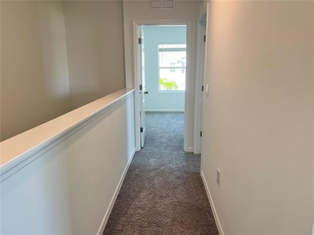 137 Mangrove Shade Circle Apollo Beach, FL 33572 - Photo 23 of 31 a view of a hallway with wooden floor