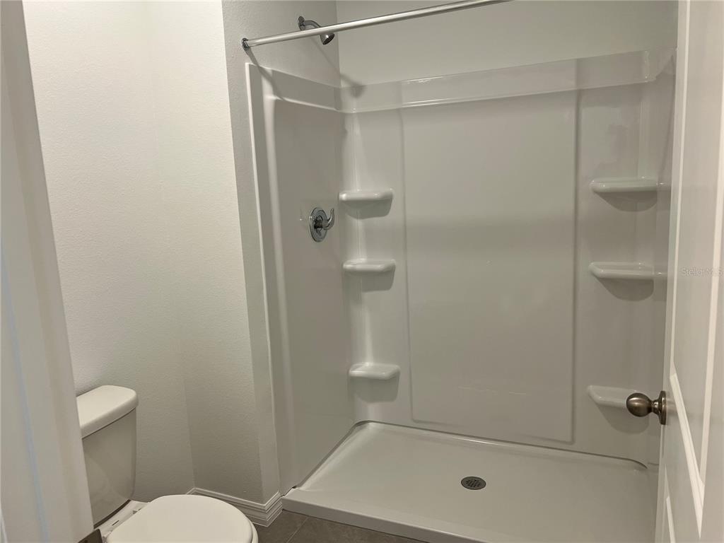 137 Mangrove Shade Circle Apollo Beach, FL 33572 - Photo 27 of 31 a bathroom with a shower and toilet