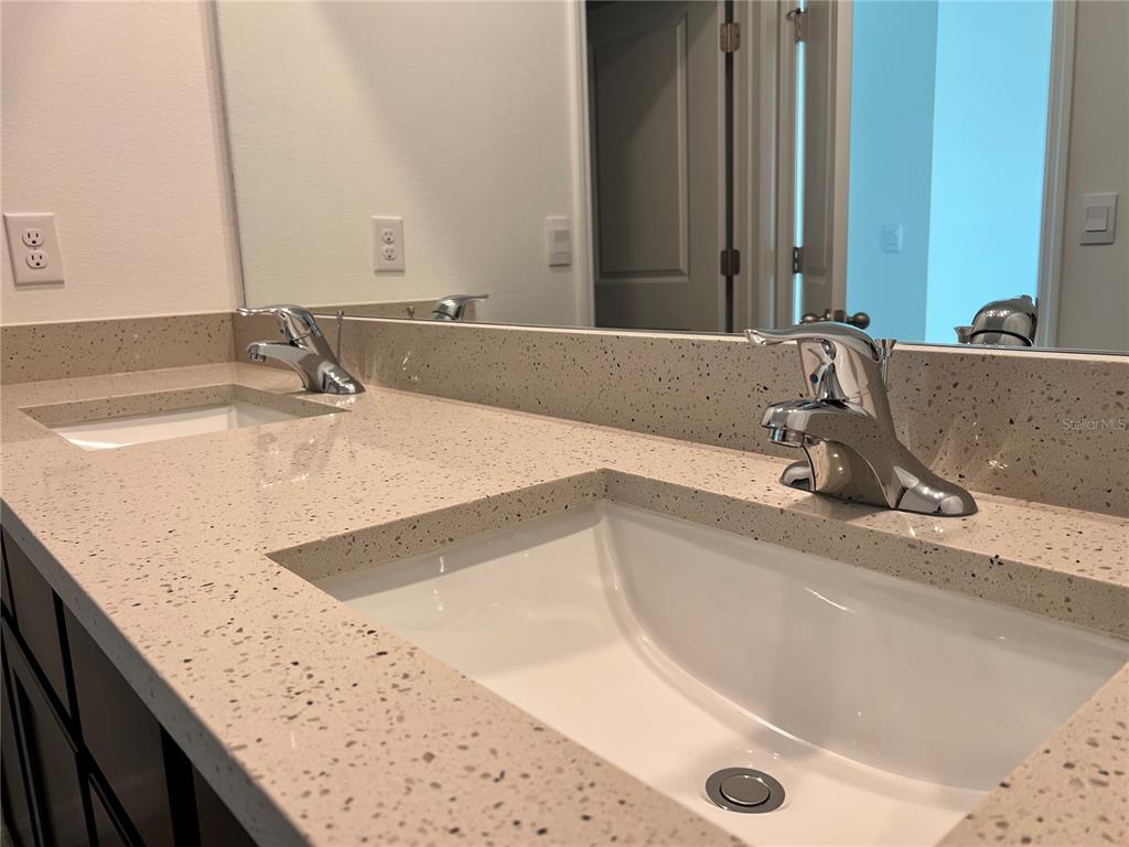 137 Mangrove Shade Circle Apollo Beach, FL 33572 - Photo 28 of 31 a bathroom with a granite countertop sink and a bathtub
