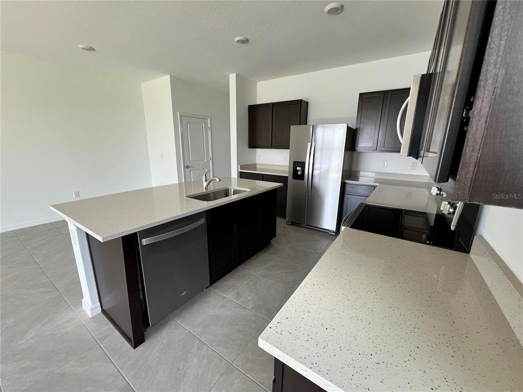 137 Mangrove Shade Circle Apollo Beach, FL 33572 - Photo 6 of 31 a kitchen with stainless steel appliances a refrigerator and a stove
