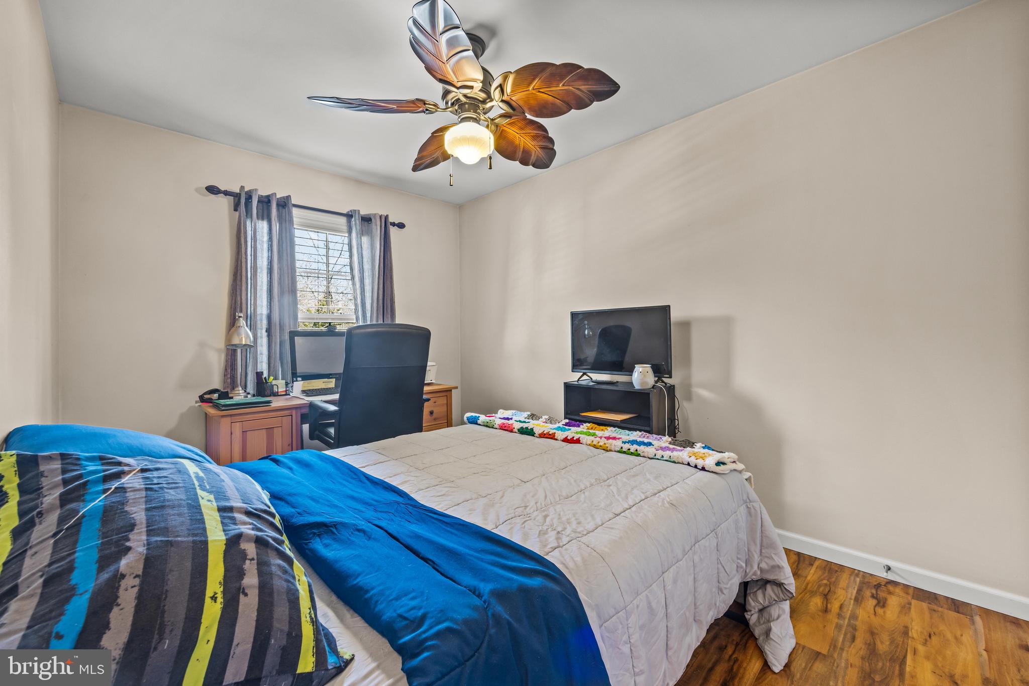 141 Pine Trail Delta, PA 17314 - Photo 19 of 44 a bedroom with a bed and a chandelier