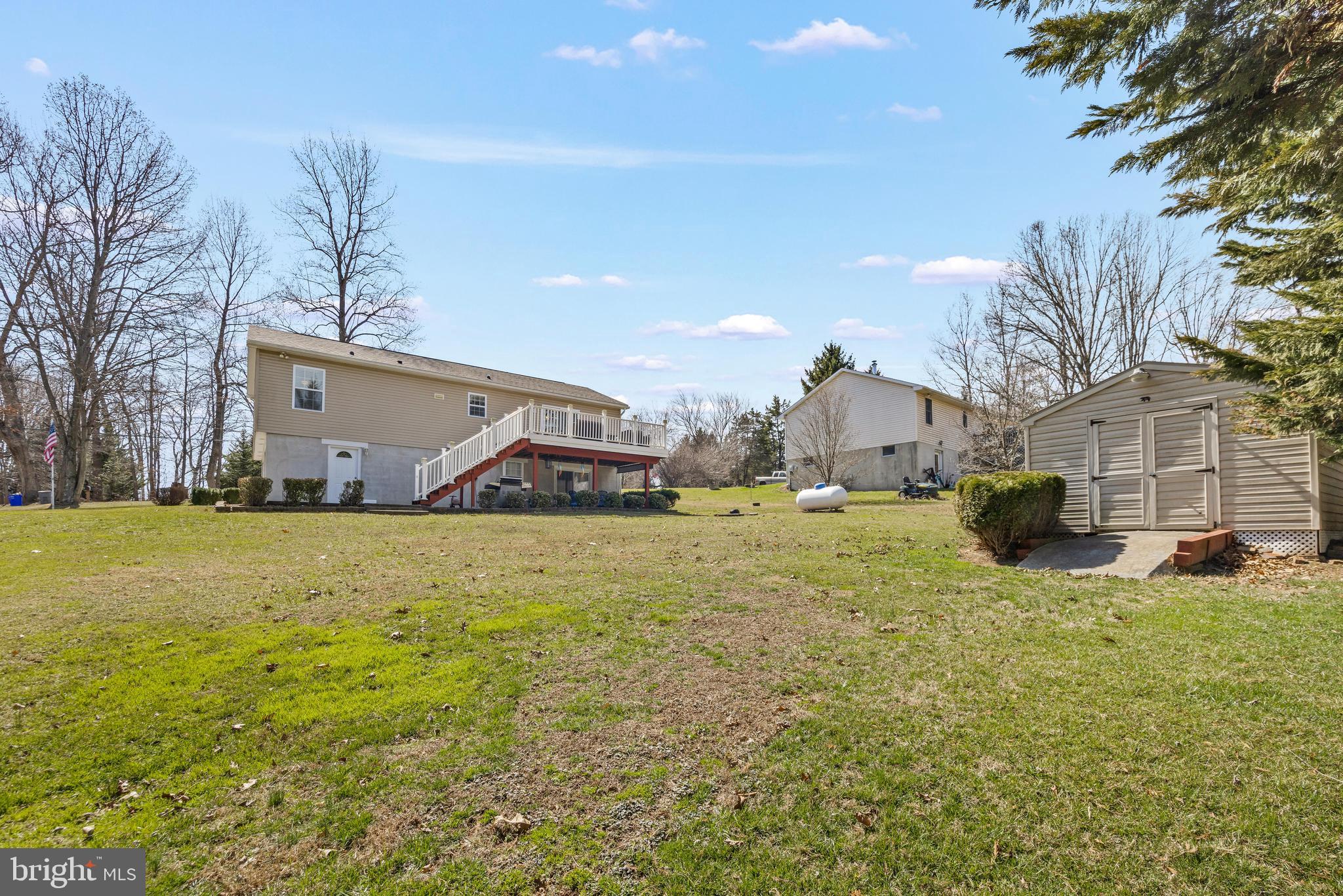 141 Pine Trail Delta, PA 17314 - Photo 32 of 44 a view of a house with a yard and garage