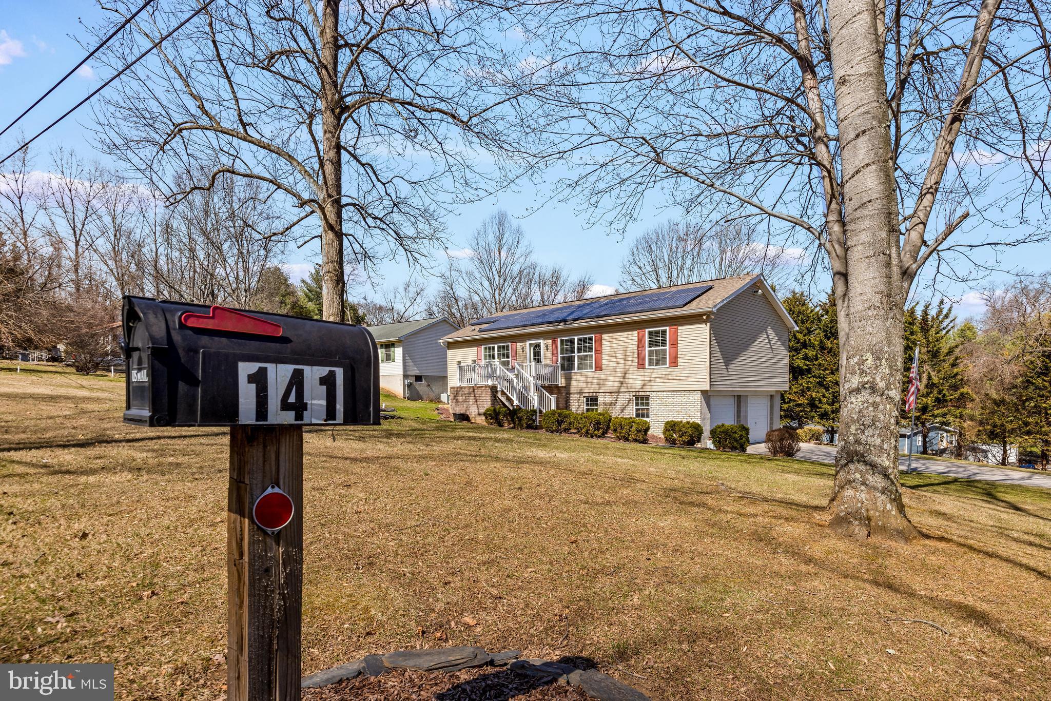 141 Pine Trail Delta, PA 17314 - Photo 42 of 44 a front view of a house with a yard covered with snow and trees