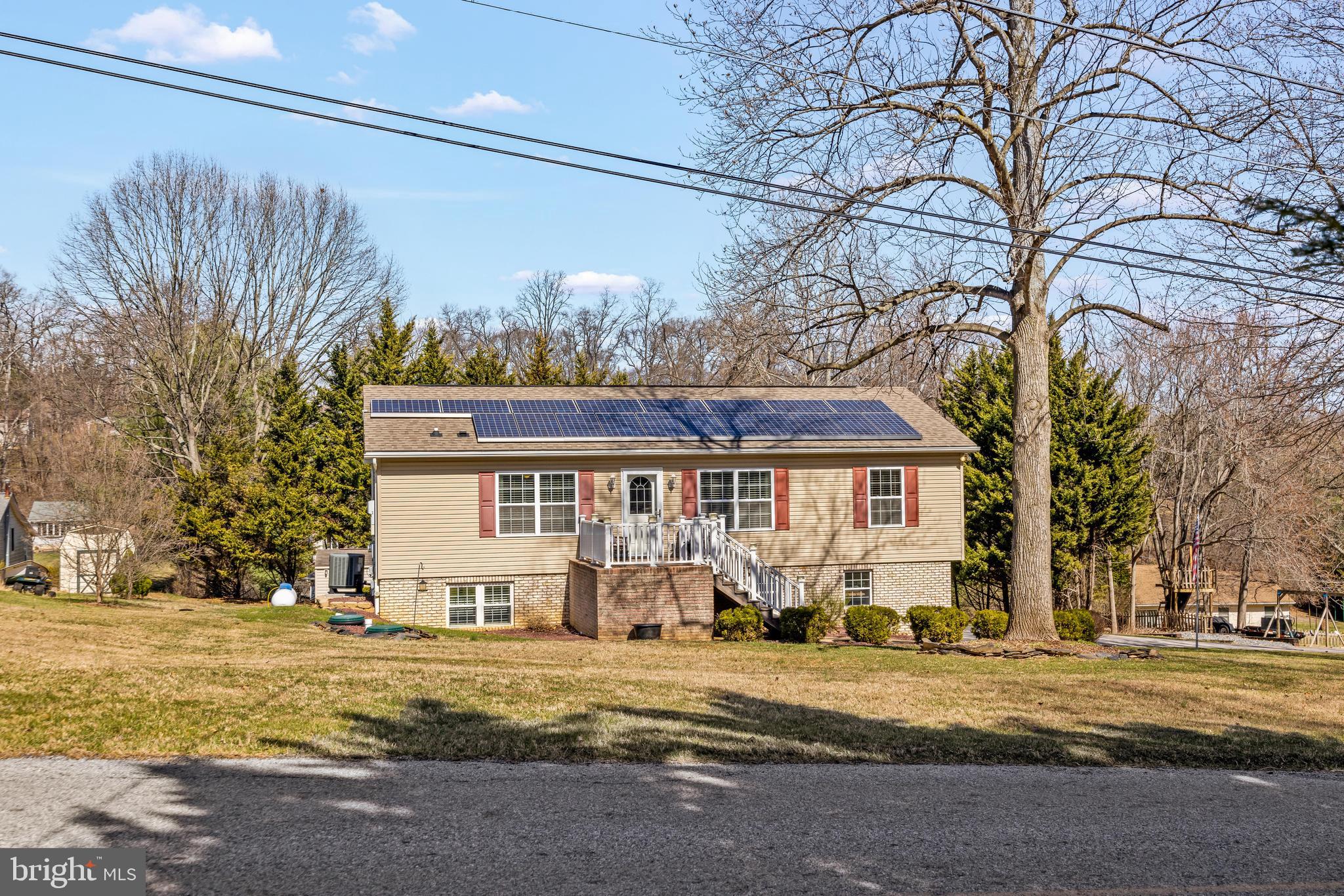 141 Pine Trail Delta, PA 17314 - Photo 43 of 44 a front view of a house with a yard and garage