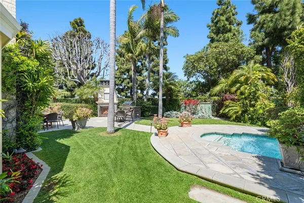 a view of a backyard with plants and patio