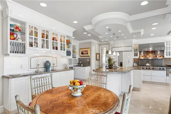 a large kitchen with a table and chairs