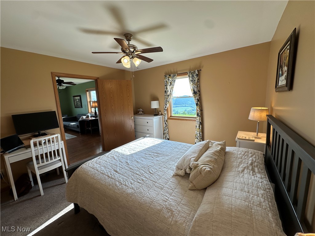 18331 Davis Ridge Road Caldwell, OH 43724 - Photo 15 of 31 Bedroom featuring a desk and a ceiling fan