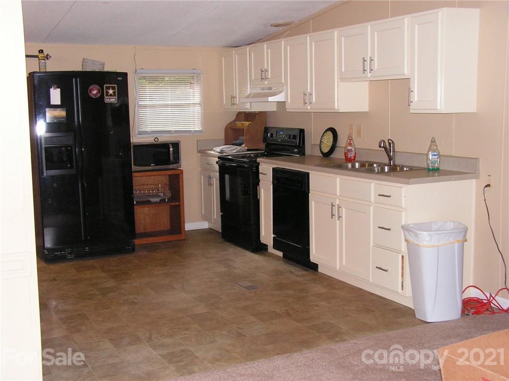 1054 State Rd S-11-141 Blacksburg, SC 29702 - Photo 3 of 7 a kitchen with a sink stove and refrigerator