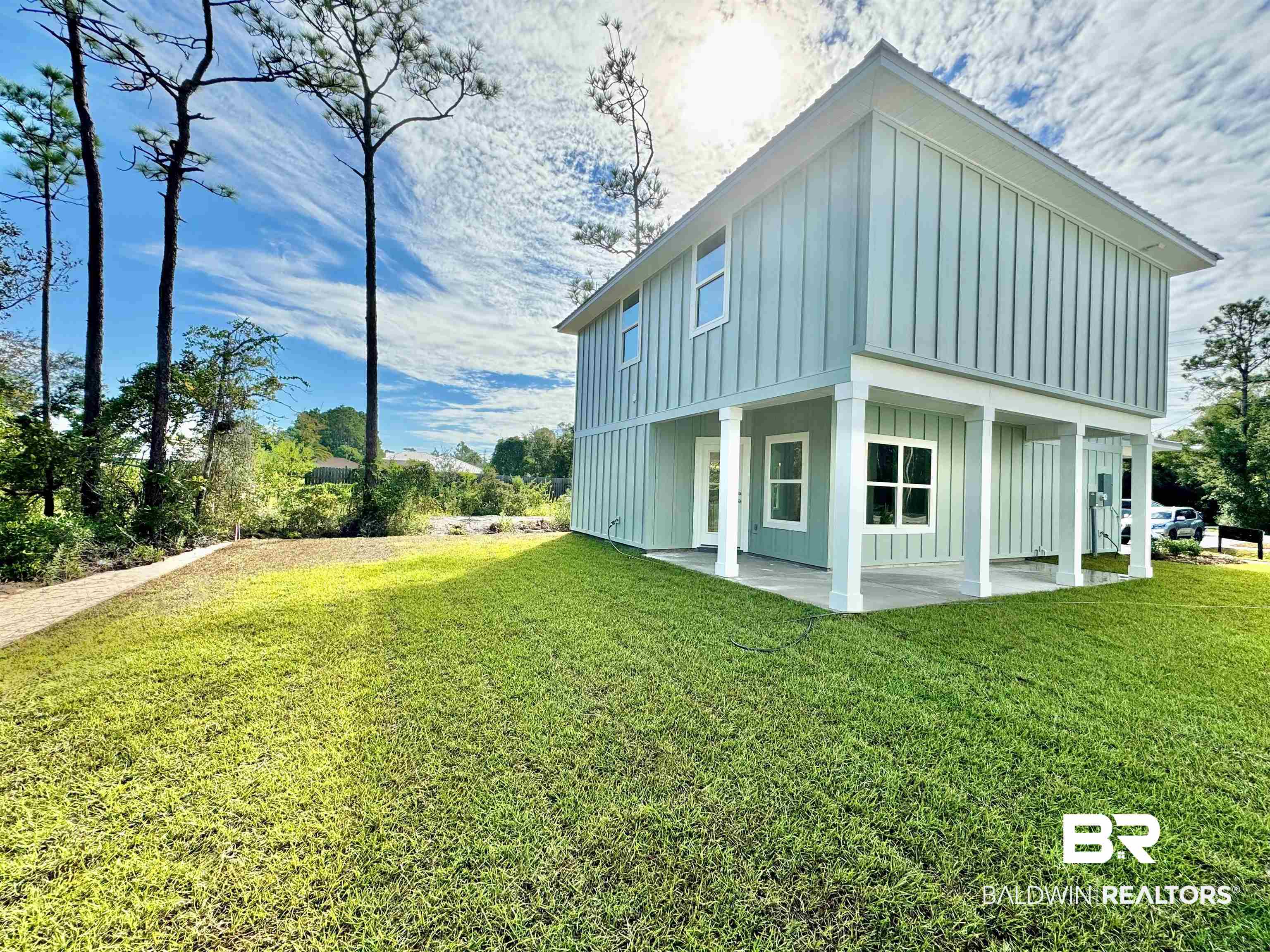 27491 Canal Road Orange Beach, AL 36561 - Photo 6 of 20 Rear view of house with a yard
