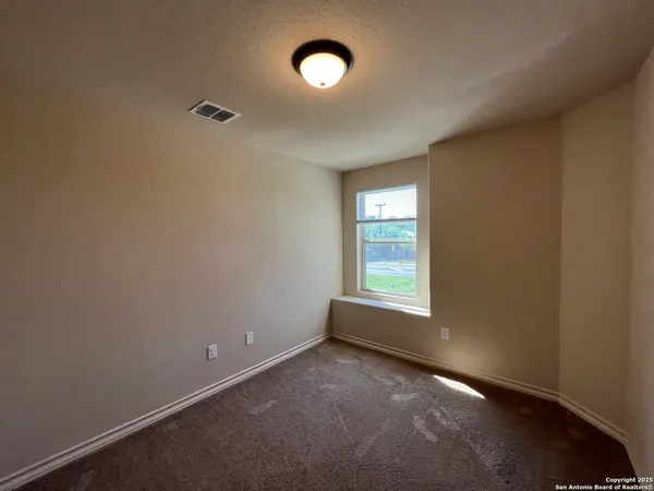 a bathroom with a granite countertop sink and a toilet