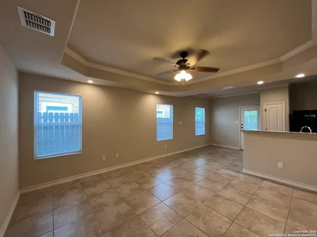 a view of a livingroom with a ceiling fan and window