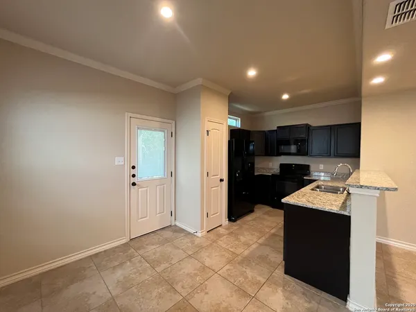 a kitchen with stainless steel appliances granite countertop a refrigerator and a stove