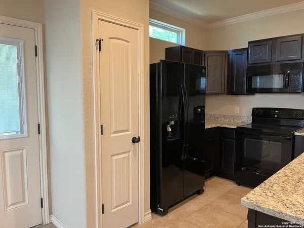 a kitchen with stainless steel appliances granite countertop a refrigerator and a stove