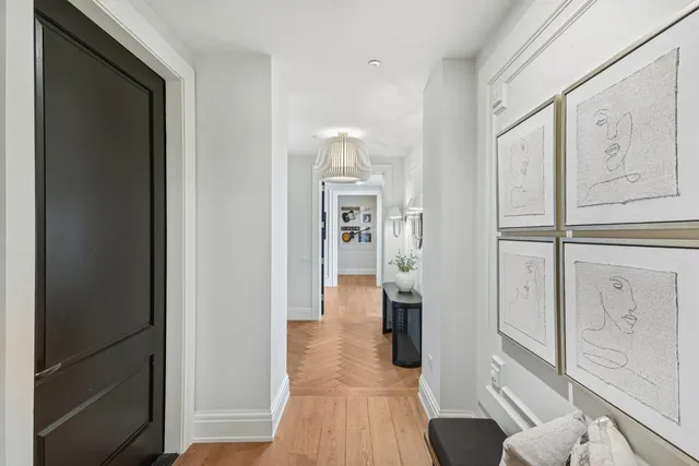 a view of a hallway with wooden floor and furniture