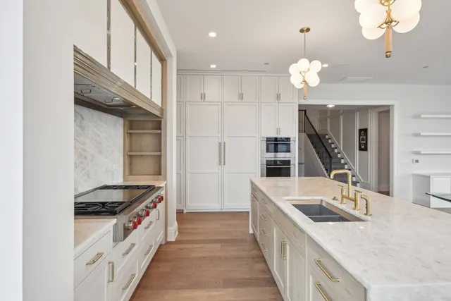 a kitchen with a stove a sink and a refrigerator
