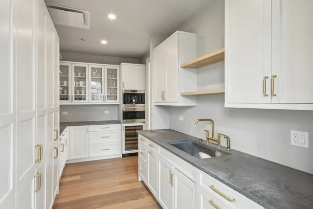 a kitchen with stainless steel appliances granite countertop a stove and a sink