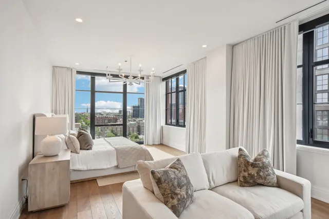 a spacious bedroom with two beds and a large window