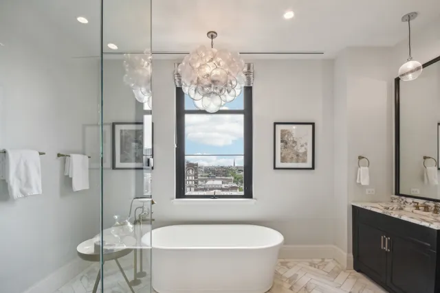 a bathroom with a granite countertop sink mirror and toilet