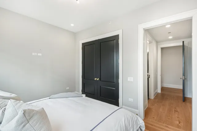 a bathroom with a granite countertop sink a toilet a shower and a mirror