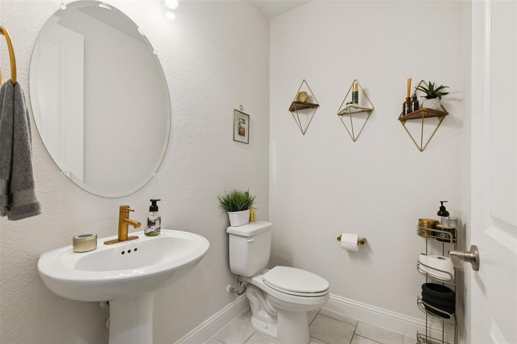 2236 Madison Street Carrollton, TX 75010 - Photo 12 of 37 a bathroom with a sink mirror and toilet