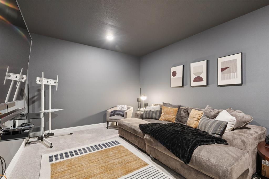 2236 Madison Street Carrollton, TX 75010 - Photo 13 of 37 a bedroom with a bed and a flat screen tv