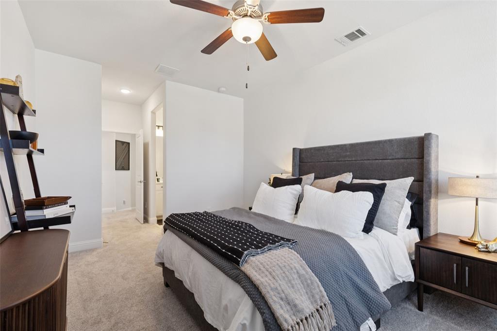 2236 Madison Street Carrollton, TX 75010 - Photo 15 of 37 a bedroom with a bed and a chandelier