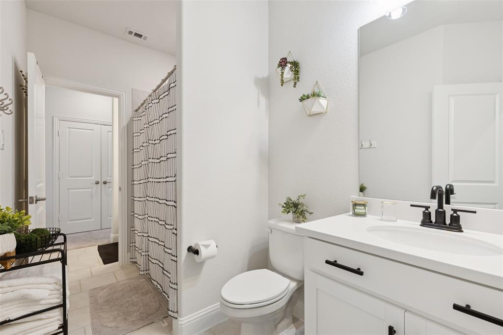 2236 Madison Street Carrollton, TX 75010 - Photo 16 of 37 a bathroom with a sink a toilet and shower