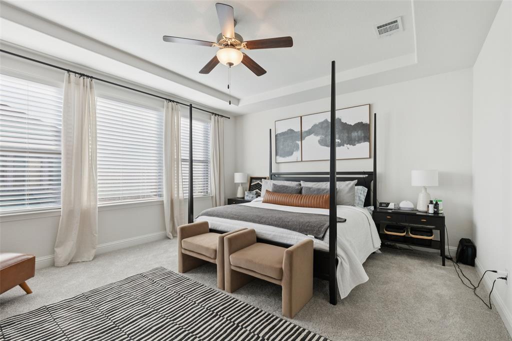 2236 Madison Street Carrollton, TX 75010 - Photo 21 of 37 a bedroom with a bed a chandelier and a window
