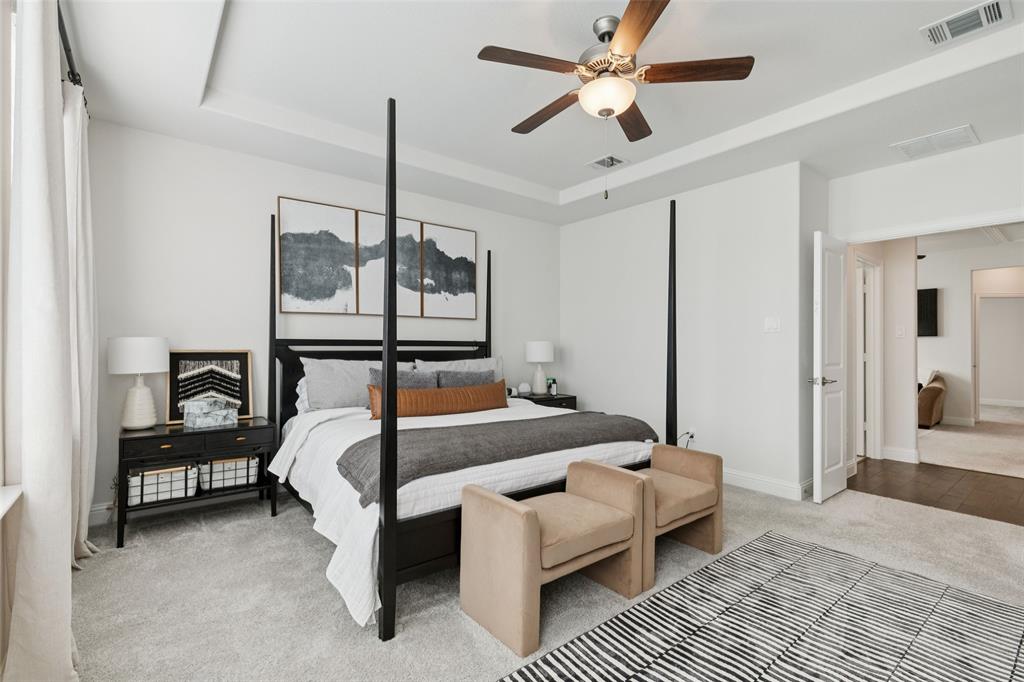 2236 Madison Street Carrollton, TX 75010 - Photo 23 of 37 a bedroom with a bed and a chandelier